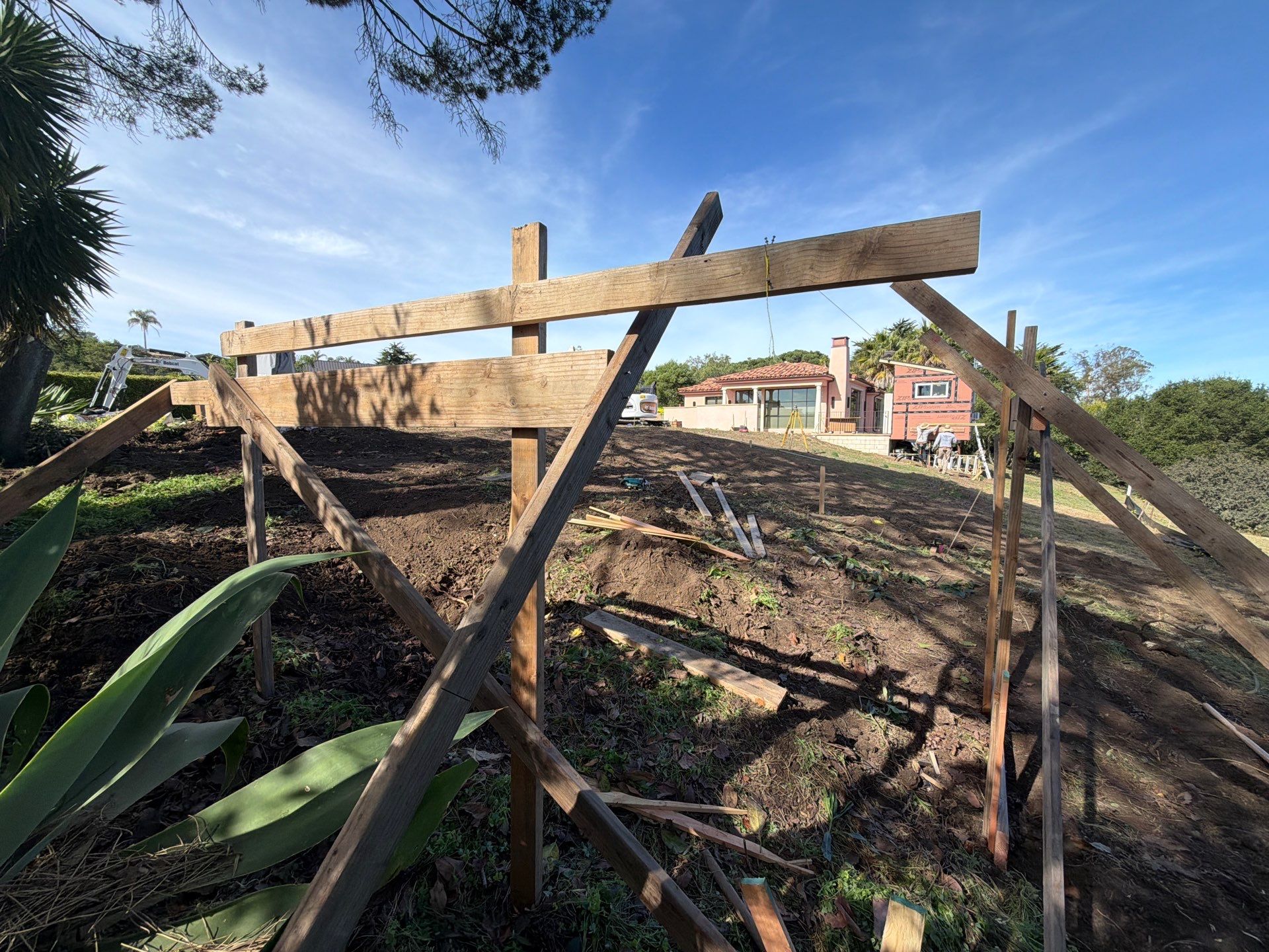 Finished batterboard with diagonal braces and string line running to the next reference point