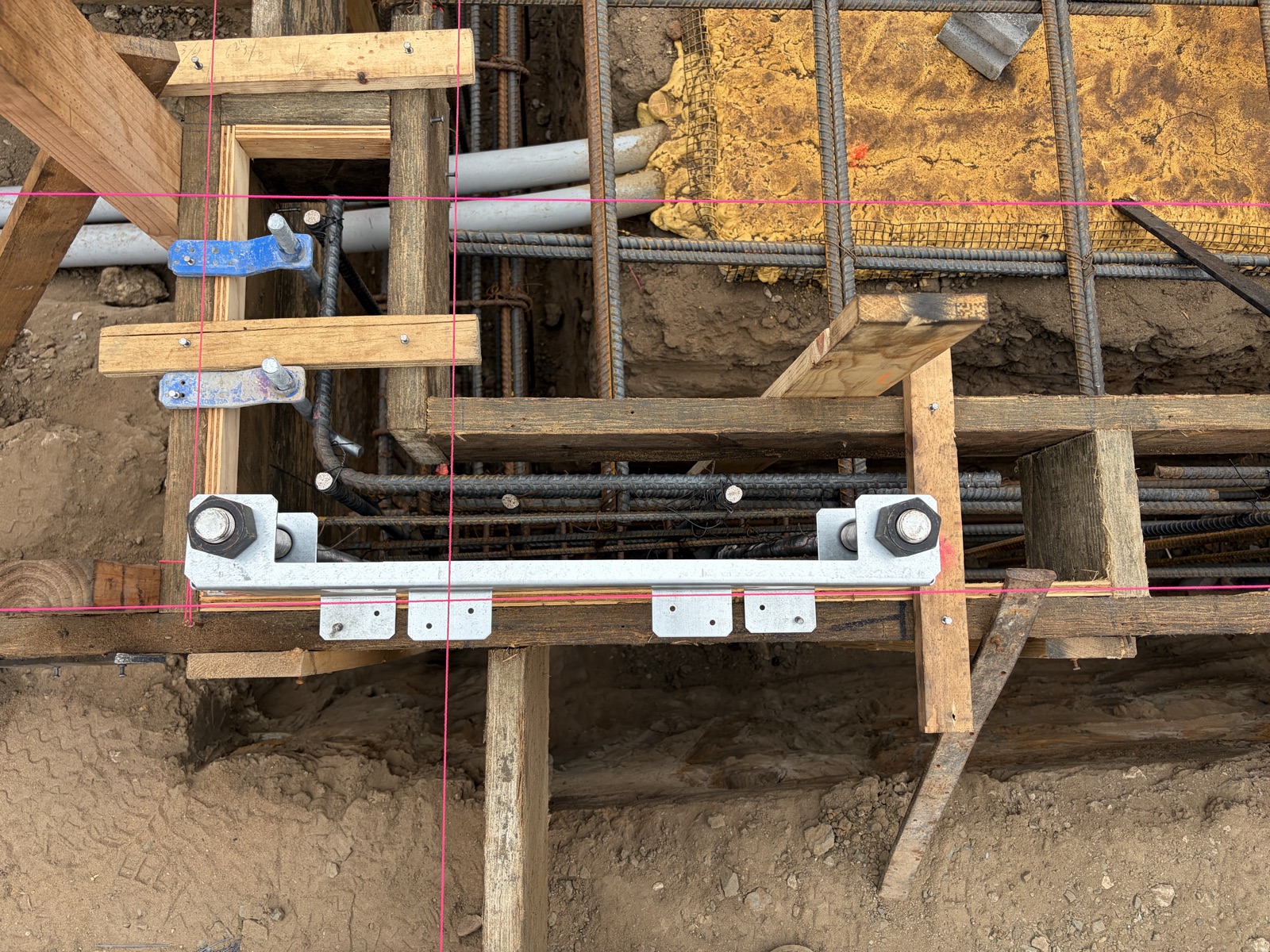 Strong-Wall anchor bolts held in the Simpson template across the rebar cage before the pour
