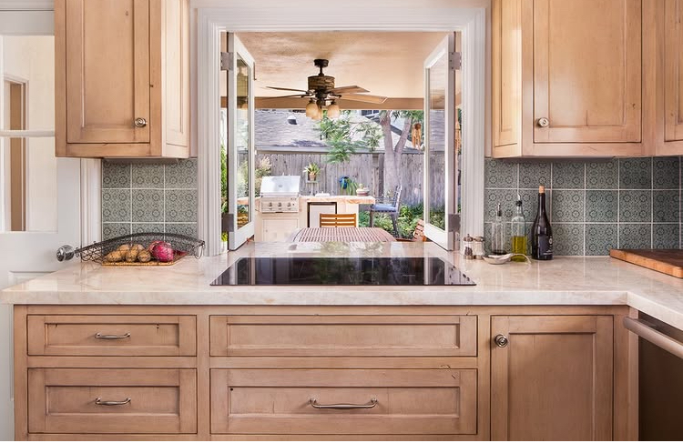 Kitchen remodel with natural wood cabinetry and outdoor living connection