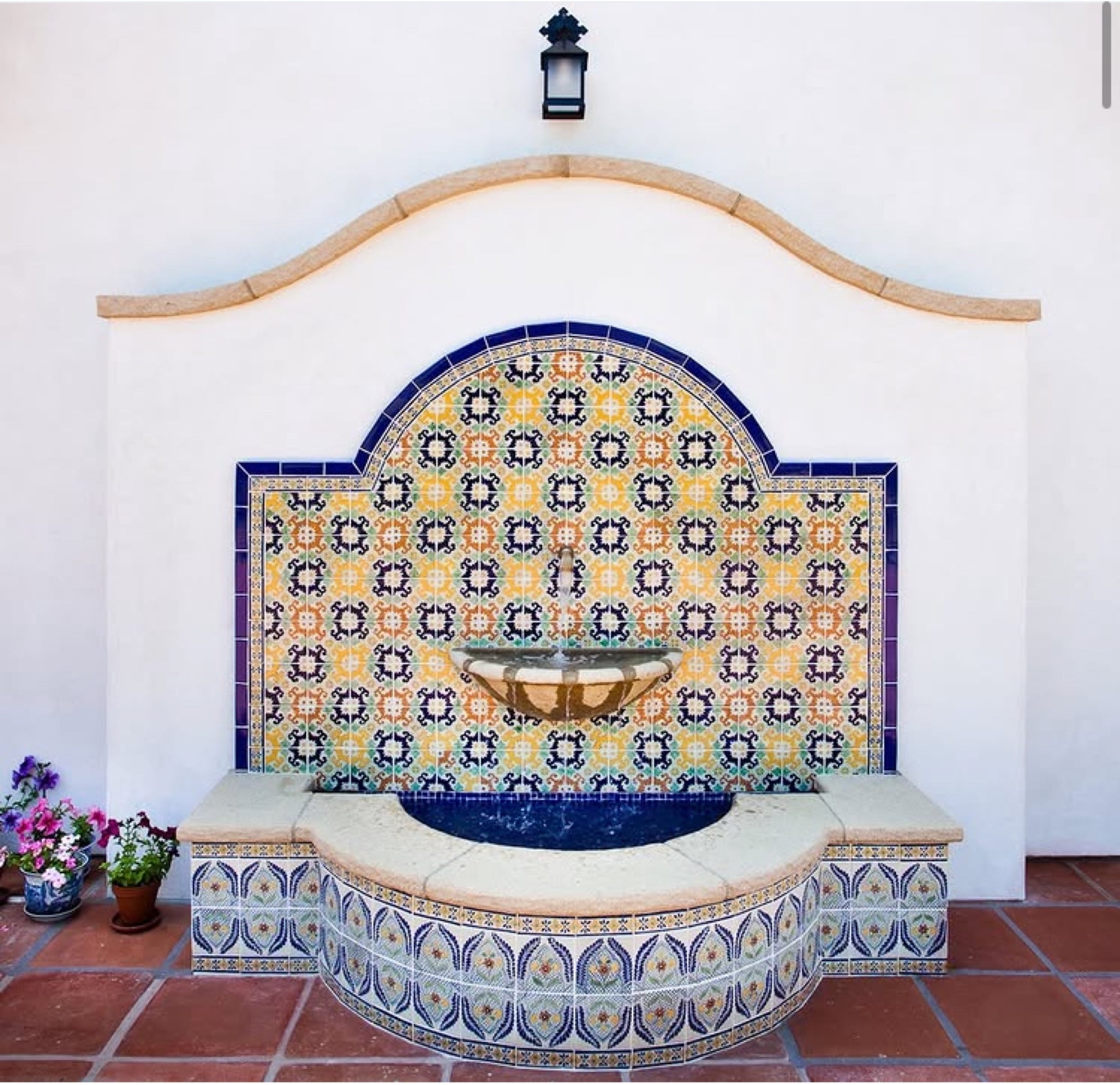 Spanish tile fountain with hand-painted mosaic and stone basin