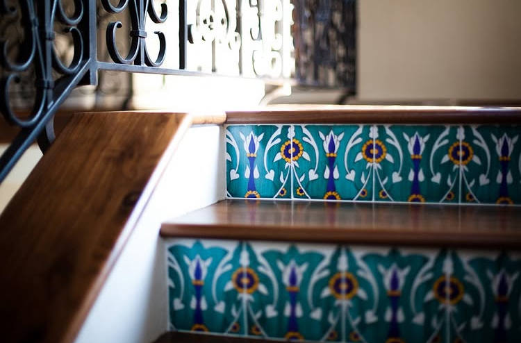 Staircase with hand-painted Spanish tile risers and wrought iron railing