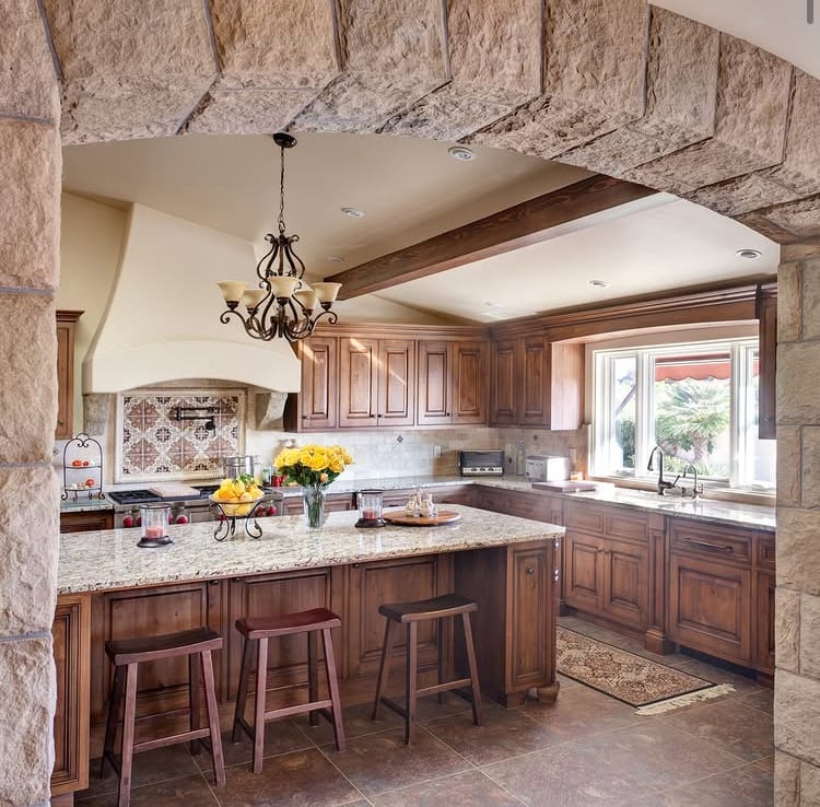 Kitchen with stone archway and custom cabinetry